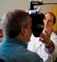 Asheville Eye Associates doctor checks patient's perscription